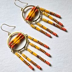 An Array Of Yellow, Gold And Orange Seed Beads Dangle Down These Native American Style Earrings. Handmade. Bohemian Yellow Beaded Dangle Earrings, Yellow Colorful Beaded Drop Earrings, Colorful Beaded Drop Earrings In Yellow, Yellow Beaded Drop Earrings With Colorful Beads, Yellow Beaded Drop Earrings With Dangling Beads, Yellow Bohemian Dangle Earrings, Yellow Bohemian Drop Earrings, Yellow Beaded Earrings With Gold Round Beads, Yellow Gold Beaded Round Earrings