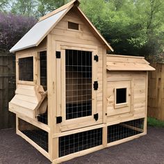 a large wooden chicken coop with windows on the roof