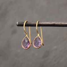 Teardrop Gemstone and Gold Vermeil Drop Earrings Faceted Amethyst and gold vermeil teardrop earrings, with a hook fitting.  Amethyst is the birthstone for the month of February.  Dimensions (approx): * Length: 2.5cm including hook * Drop: 1.2cm  * Width: 0.8cm  Materials: * Gold Vermeil  * Amethyst  Beyond Biasa creates unique jewellery that is inspired by antique and tribal designs from around the globe. All of our pieces are handmade so please allow for slight variations in size and colour. Amethyst Earrings Gold, Large Statement Earrings, Gemstone Earrings Gold, Drop Earrings Gold, Aqua Chalcedony, February Birthstone, Amethyst Earrings, Blue Chalcedony, Green Amethyst