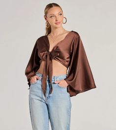 This silky satin crop top features trendy kimono half-length sleeves and a tie-front design making it perfect for layering or styling on its own. Fit & FeaturesSatin woven fabric, no stretchKimono half-length sleevesTie-front designCropped length hemRuns true to size Trendy Satin Crop Top, Spring Cropped Satin Blouse, Chic Cropped Satin Blouse, Satin Cropped Shirt, Satin Triangle Crop Top, Chic Satin Wrap Blouse, Semi-formal Satin Top With Button Closure, Satin Tie Front Top, Orange Homecoming Dresses