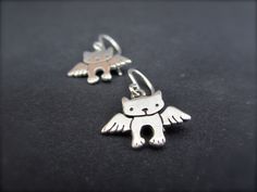 A very sweet tribute for your cat. They are 1/2 of an inch tall and handmade using solid sterling silver with solid sterling French ear wires. These will make you smile through those hard days. For the large matching necklace: https://www.etsy.com/listing/106961895/angel-kitty-necklace For the small matching necklace: https://www.etsy.com/listing/106971983/tiny-angel-kitty-necklace For the mother-daughter set: https://www.etsy.com/listing/106580243/mother-daughter-angel-cat-set Items are shipped Cute Sterling Silver Earrings With Ear Wire, Nickel-free Cat Ears Jewelry For Gifts, Nickel-free Cat Ears Jewelry Gift, Sterling Silver Cat Ears Earrings, Sterling Silver Cat Ears Earrings Gift, Sterling Silver Cat Design Earrings For Gift, Whimsical Sterling Silver Pierced Earrings, Handmade Silver Cat Ears Jewelry, Cat Memorial Jewelry