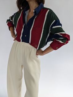 Lovely bold striped button down by 90s Tommy Hilfiger. The button down has colors of crimson, navy, forest and ivory with a thin ivory stripe, embroidered crest under the chest pocket and front blonde tortoise button closures. Tag reads Tommy Hilfiger Tommy Hilfiger Aesthetic, Natalie Borton, 90s Tommy Hilfiger, Knit Outerwear, Line Shopping, Linen Shop, Dress Suits, Shop Swimwear, Vintage Cotton