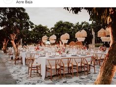 an outdoor dining area with tables and chairs set up for a formal function in the evening