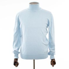 Slip into comfortable designer stylings in this handsome long-sleeved turtleneck with a traditional ribbed cuff design for versatility when paired with casual or semi-formal outfits. Blue Long Sleeve Turtleneck With Ribbed Cuffs, Classic Funnel Neck Turtleneck With Ribbed Collar, Classic Turtleneck With Ribbed Collar, Casual Cashmere Turtleneck With Ribbed Collar, Fitted Blue Sweater With Ribbed Collar, Blue Funnel Neck Top With Ribbed Cuffs, Blue Turtleneck For Winter Layering, Classic Fine Knit Polo Sweater For Spring, Blue Long Sleeve Turtleneck For Fall