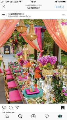 a long table covered in lots of pink and orange flowers