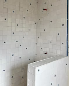 an unfinished bathroom with blue and white tiles on the walls