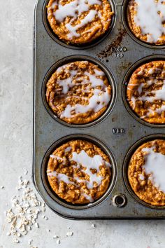 muffins with icing in a pan on a table