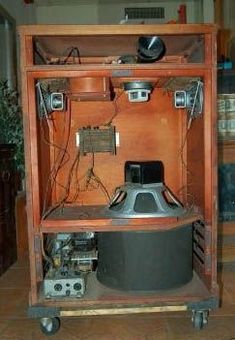 an old wooden cabinet with electronic equipment in it