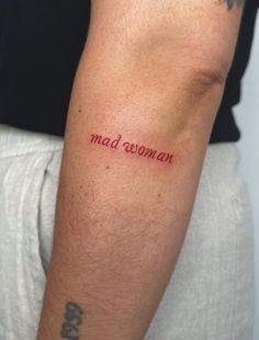 a man with a tattoo on his arm that says mad women in red ink,