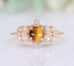 a ring with a tiger's eye in the center and white diamonds around it