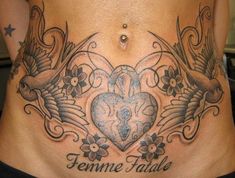 a woman's stomach with tattoos on it