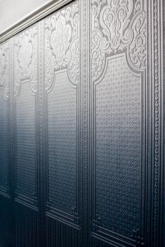 a close up of a metal door with intricate designs on the outside and inside wall