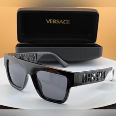 The Renowned Versace Eyewear Brand Features Contemporary Shapes And The Iconic Emblem Of The Brands Own Mythology, The Medusa. Frame Shape - Rectangle Frame Material - Injected Frame Type - Full Rim Gender - Men's Bridge/Temple Width - 20/140 Lens Features - Polarized Best For Face Shape - Oval, Round Low Bridge Fit - No Designer Black Sunglasses For Business, Contemporary Shapes, Versace Eyewear, Versace Gold, Sunglasses Logo, Versace Accessories, Rectangle Frame, Versace Sunglasses, Rimless Sunglasses