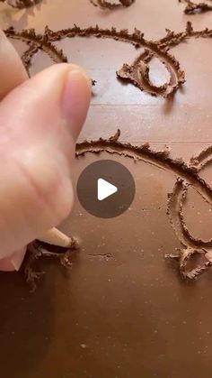 someone is drawing the word love in chocolate