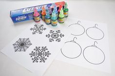 snowflakes, crayons and markers are sitting on the table next to each other