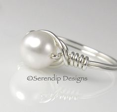 Wire Wrapped White Pearl Ring Solitaire in by SerendipDesignsJewel, $19.00 Wire Wrapped Pearl Wedding Ring, Elegant Wire Wrapped Pearl Ring For Wedding, Elegant White Wire Wrapped Pearl Ring, Elegant Wire Wrapped Pearl Wedding Ring, Elegant Wire Wrapped Wedding Rings, White Wire Wrapped Pearl Ring For Wedding, Elegant Wire Wrapped Round Rings, Wired Jewelry, Diy Wire Jewelry Rings