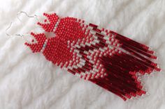 a red and white beaded bird ornament