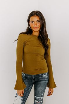 - Give your OOTD a touch of trendy flair with this cutie! - Unlined tight knit material with a ribbed texture - A round neckline - Long bell sleeves - A figure flattering silhouette that ends in a straight hemline Casual Olive Long Sleeve Tops, Olive Long Sleeve Summer Tops, Olive Fitted Long Sleeve Tops, Olive Long Sleeve Buttoned Tops, Long Sleeve Brown Top With Ruched Detail, Martini Olives, Martini Olive, Long Bell Sleeves, Ribbed Top