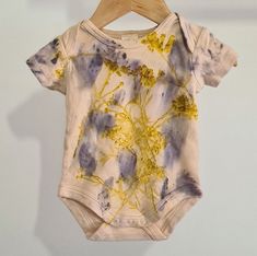 Unique clothing for your baby botanically hand dyed by us! Our botanically dyed clothing are lovingly designed and hand dyed in our studio in Western Australia. Made from organic fibers and natural dyeing techniques, the plants selected to dye our clothing are organically grown or foraged. Our Lotus Bodysuit was naturally dyed with windfallen leaves and flowers, and infused with Pink Everlasting Australian Bush Flower Essence. The essence of Replenishment and Inspiration. Due to our clothing being hand dyed, each garment will be uniquely one of a kind with fabric print and placement varying for each individual piece of clothing. Sizing  Size ~ 00 (3-6 Months) Height ~ 68cm Chest Circumference ~ 47cm Features ~ Soft Cotton ~ Snaps at Gusset ~ Lightweight ~ Unique design ~ Botanically Dyed i Natural Dyeing Techniques, Hand Dyed Clothing, Dye Flowers, Australian Bush, Natural Dyeing, Cotton Labels, Flower Essences, Dyeing Techniques, Unique Clothing