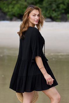 Turn heads at the beach with our Black Half Sleeve Tassel Tie Mini Cover-Up Dress! Featuring playful tassel ties and flattering half sleeves, this versatile piece effortlessly transitions from beachside chic to poolside glamour. Product code: DAA07B4B017AA Features:  Woven Plunging neckline Tassel tie Lace detail Mini Wash Method: Regular Wash Material: 60%RAYON,40%POLYESTER. Black Beach Dress With 3/4 Sleeve, Black 3/4 Sleeve Beach Dress, Beach Dresses With 3/4 Sleeves For Summer, Chic Short Sleeve Beach Dress For Vacation, Flowy Half Sleeve Beach Dress, Bohemian Half Sleeve Dresses For Vacation, Half Sleeve Summer Vacation Dresses, Summer Vacation Dress With Half Sleeves, Summer Vacation Dresses With Half Sleeves