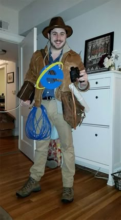 a man wearing a hat and holding a blue frisbee