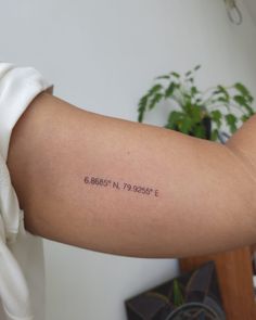 a person with a tattoo on their arm that reads 6, 868 in 7, 789 e