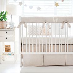 a white crib in a room with stars on the wall