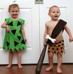 two young children dressed in costumes standing next to each other