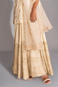 Off white short kurta with golden metallic floral hand block prints. Comes with matching printed sharara and dupatta. - Aza Fashions Gold Palazzo Set With Gold Embroidery In Chanderi, Off White Sharara With Gota Work For Diwali, Diwali Off White Sharara With Gota Work, Cream Sharara With Gota Work For Diwali, Traditional Gold Palazzo Set With Gold Embroidery, Traditional Gold Palazzo Set With Chikankari Embroidery, Gold Sharara With Chikankari Embroidery, Fitted Gold Palazzo Set With Chikankari Embroidery, Gold Chikankari Embroidered Palazzo Set For Wedding