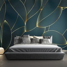 a bed sitting in front of a wall covered in green and gold leafy designs