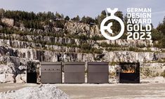 the german design award for gold 2012 is displayed in front of some rocks and trees