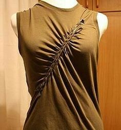 a mannequin wearing a brown top with an arrow on it