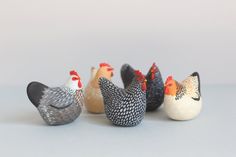 five small chicken figurines sitting next to each other