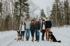 a group of people standing next to each other in the snow