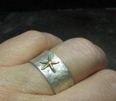 "Starfish ring - express your inner beachcomber with this cute little sterling silver starfish ring! A golden brass starfish rests on a background of brushed sterling silver to bring a hint of the beach to your day. A perfect little ring comfortable to wear and easy to mix and match with many styles both dressy and casual. The ring is 10mm wide (3/8\"), and has been hammered with a texture to remind of the dappled surface of a tidal pool. The finish is a brushed satin finish that allows the star Summer Jewelry Beach, Starfish Ring, Tidal Pool, Sea Life Jewelry, Stella Marina, Casual Rings, Jewelry Beach, Tide Pools, Beach Combing