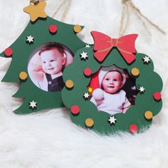 two christmas tree shaped photo frames with a bow on the top and an ornament in the middle