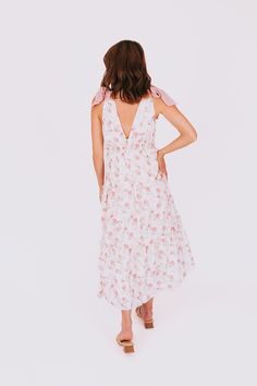 Get ready to turn heads with our EXCLUSIVE Make You Mine Dress! The v-neckline, ribbon straps, and elastic under bust not only create a flattering fit, but also add a touch of elegance. And with a beautiful floral pattern, you'll be sure to stand out at any event. You'll be the envy of everyone (including us) in this must-have dress!! Details V-neckline Ribbon straps Elastic under bust Floral pattern Sizing *Measurements are taken with item hanging and fabric unstretched.* Approximate measurements: SIZE LENGTH BUST XS 47” 30” Small 48" 32" Medium 48” 34” Large 48” 36” X-Large 50" 38" 1XL 51" 40" 2XL 52" 42" 3XL 53" 44" Runs small, consider sizing upFabric has no stretchModels are 5’8” wearing small and 5'6" wearing 1XL Material Self: 100% Polyester, Lining: 100% PolyesterHand wash cold Do Feminine Tie Straps Maxi Dress For Beach, Feminine Tie-straps Maxi Dress For Beach, Feminine Beach Maxi Dress With Tie Straps, V-neck Midi Dress With Tie Straps For Vacation, V-neck Vacation Dress With Knotted Straps, Feminine V-neck Dress With Adjustable Straps, V-neck Dress With Knotted Straps For Vacation, V-neck Sundress With Tie Back For Brunch, Feminine V-neck Sundress With Tie Back