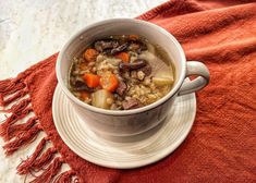 a white bowl filled with soup on top of a red towel