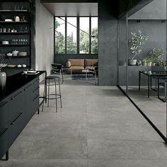 a modern kitchen with black cabinets and counter tops