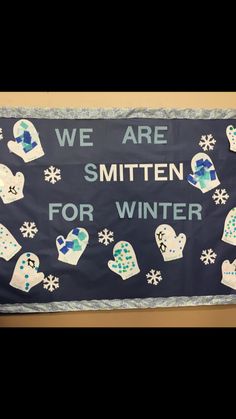 a sign that says we are smitten for winter with snowflakes on it