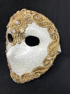 Full Face Moretta Mask. Size: one size Traditional and original papier-mache Venetian mask, handmade and decorated with burano macramè lace,gold leaf or silver leaf,and swarovski crystal. The mask has double paper mache. All our masks are handmade papier-machè masks made in Venice. Our decorators use techniques typical of the Venetian tradition such as stucco, acrylics, gold and silver-leaf, macramè, passementerie, pearls and crequelè to give you a wide range of masks. The mask could be slightly Full Face Masks, Full Face Masquerade Mask, Mask Venetian, Handmade Mask, Victorian Masks, Full Mask Design, Full Face Mask Design Ideas, Full Face Mask Design, Greek Masks