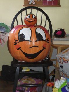 a pumpkin sitting on top of a wooden chair