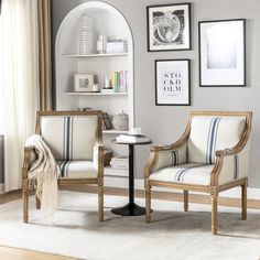 two chairs sitting next to each other on top of a white rug in front of a window