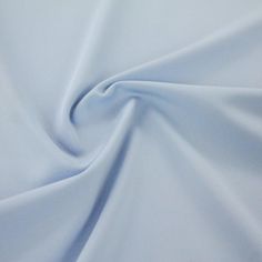 a close up view of a light blue fabric