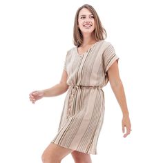 Planning a beach or poolside vacation? The Selma Dress is your go-to. This stunning, sustainable dress is the perfect cover-up that can take you from sand to dinner in a cinch. The yarn-dyed crepe fabric is breathable and has a unique, slubby feel to it. The Dolman sleeves are absolute freedom for the arms, plus they are very flattering to any body shape. Pockets at each hip are amazing and the drawcord allows you to add a bit of shape to your style. Fair Trade Certified™ and 100% organic cotton Beige V-neck Dress For Vacation, Beige Beachwear Sundress For Beach, Beige Beachwear Sundress, Beige Mini Dress For Vacation, Beige Beachy Dress For Day Out, Beachy Beige Dress For Day Out, Beige Sundress Mini Dress For Beach, Beige Sundress Mini Dress For The Beach, Beige Flowy Beach Dress