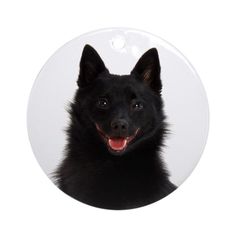 a black german shepherd dog ornament with a smile on it's face