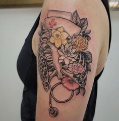 a woman's arm with flowers and a stethoscope tattoo on it