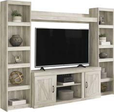 a living room with an entertainment center and large screen tv on top of the entertainment center