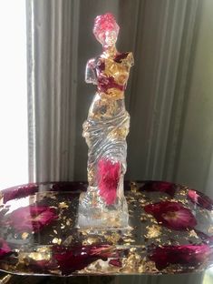 a glass figurine sitting on top of a table