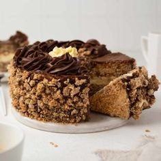 a cake that has been cut into pieces and is on a plate next to a cup